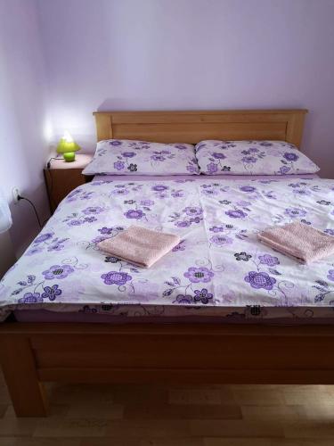 a bed with two pillows on top of it at Apartmany-Anna in Podhájska