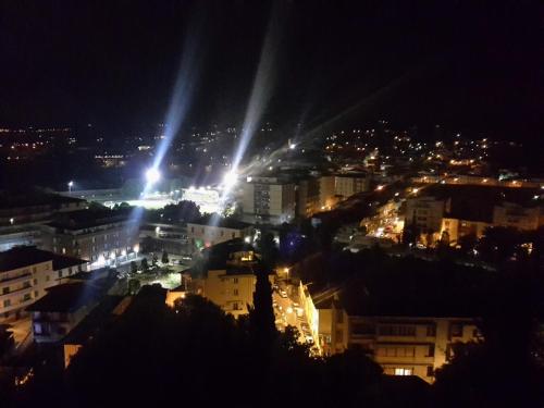 a view of a city at night with lights at B&B L'Orologio in Signa