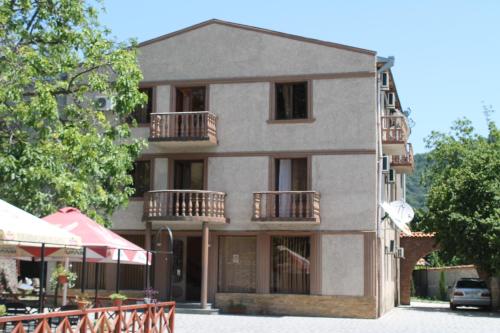 a building with balconies on the side of it at Hotel Kavkasioni in Kvareli