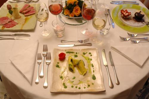 a white table with a plate of food on it at Hotel Giglio in Montecatini Terme