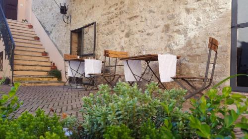 a patio with chairs and tables in front of a building at Torre della Botonta in Castel Ritaldi