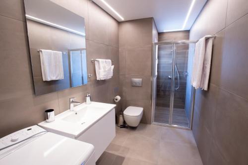 a bathroom with a sink and a toilet and a shower at Athens Center Panoramic Flats in Athens