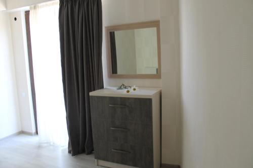 a bathroom with a sink and a mirror at Hotel Kavkasioni in Kvareli