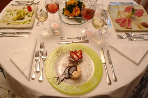 a table with a plate of food on it at Hotel Giglio in Montecatini Terme