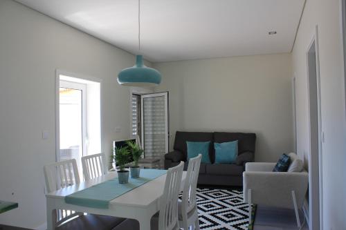 a living room with a table and a couch at Vivenda Mendes 2 in Vila Nova de Famalicão