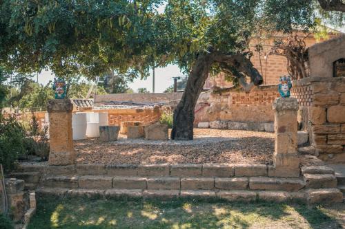 a building with a tree and some stairs at Villa La Lumia B&B Suites & Apartments in Agrigento