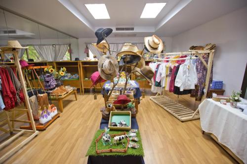 a clothing store with a lot of clothes and hats at Muaklek Paradise Resort in Ban Muak Lek