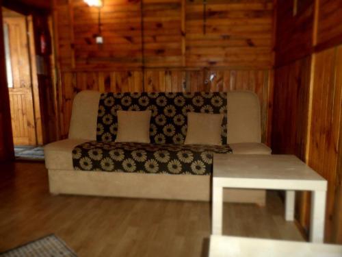 a living room with a couch and a table at Leśna Ryba in Jedlanka Stara