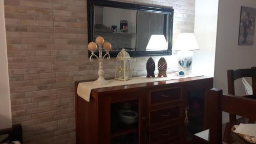 a living room with a mirror and a dresser at Little house in Alghero