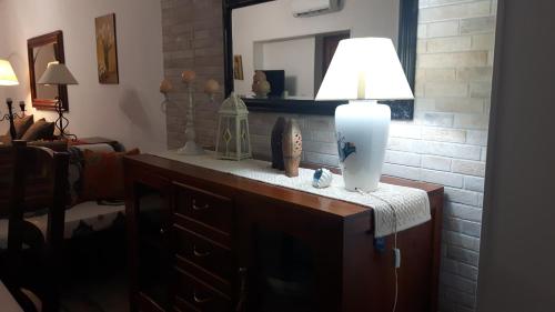 a lamp sitting on top of a dresser in a room at Little house in Alghero