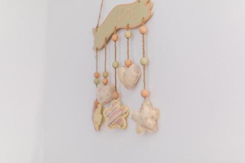 a group of beads and hearts hanging on a wall at Studio Villa Ivka in Baška