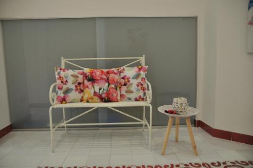 a white chair with a pillow and a table at SALERNO COSTA D'AMALFI SUITE in Salerno