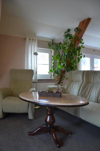 a living room with a table and a couch at Hotel Wehlener Hof in Stadt Wehlen
