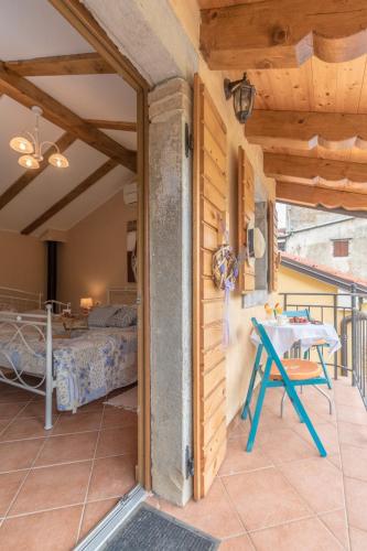 a room with a table and a bed on a balcony at Apartments Villa Sušanj in Matulji