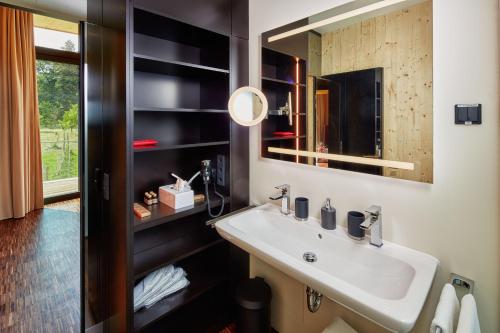 a bathroom with a sink and a mirror at Gartenlofts auf Gut Guntrams in Schwarzau am Steinfelde