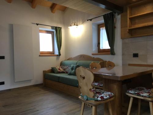 a living room with a couch and a table at Regensburgerhof in Castello Tesino