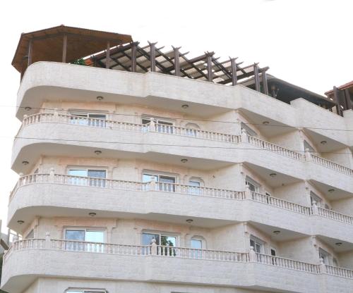 a building with balconies on the side of it at Seven Wonders Hotel in Wadi Musa