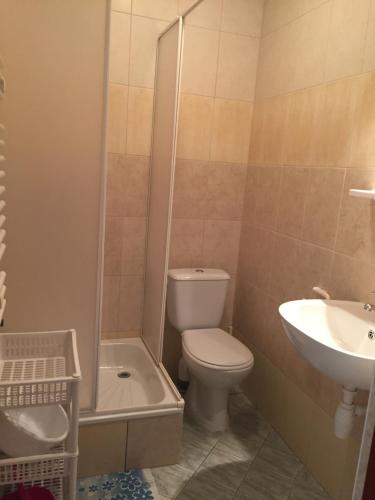 a bathroom with a toilet and a sink at Villa Malva in Karwia