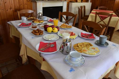 a breakfast table with breakfast foods on it at Gkoura hotel in Sirako