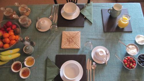 a table with plates and bowls of fruit on it at Seymours Court in Frome