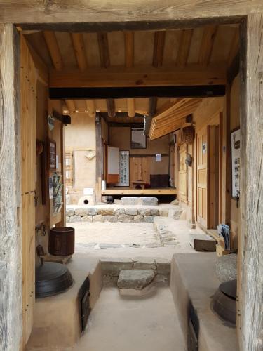 a large room with a stone floor in a building at Jukheon Traditional House in Andong