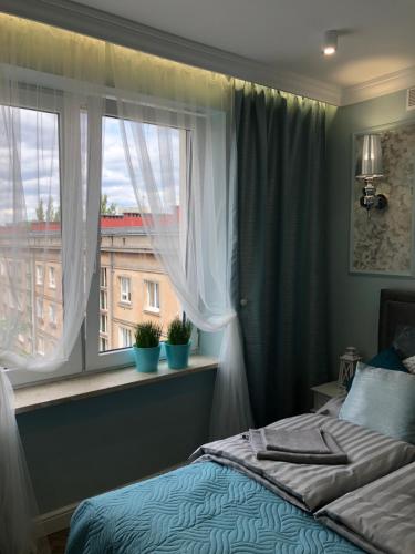 a bedroom with a bed and a window at Family & Business Sauna Apartments Paderewskiego Sienkiewicza No2 Centrum Downtown - 2 Bedroom with Private Sauna, Bath with Hydromassage, Parking in Kielce