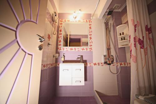 a small bathroom with a sink and a mirror at Coralli Rooms & Restaurant in Elafonisos