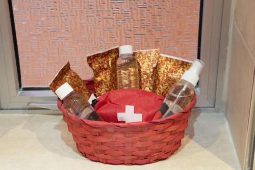 a basket with two bottles of wine and a pharmacyacistacistacistacist at For Rest Aparthotel in St Paul's Bay