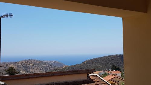 a view of the mountains from a window at Lazaros Pissouri Apartments in Pissouri