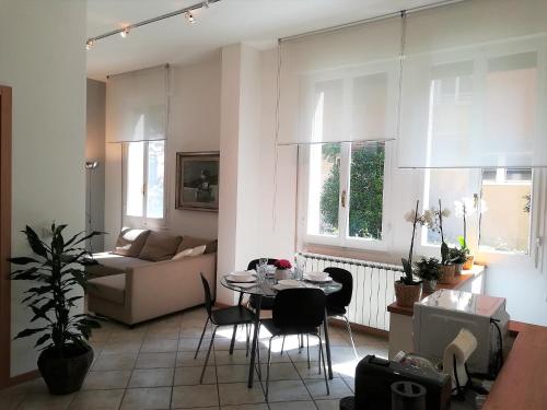 a living room with a table and a couch at Portobello Apartments in Bologna