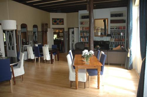 a dining room with a wooden table and chairs at Vakantiepark de Bronzen Eik in Sellingen