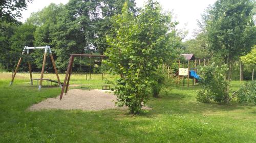 a park with a swing set and a playground at Ubytování u Šveců u Adršpachu in Jívka