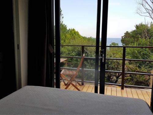 a bedroom with a view of the ocean from a balcony at Villaggio Dei Fiori in Sanremo