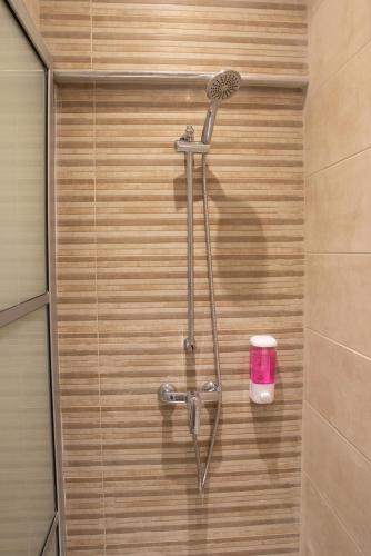 a shower with a shower head in a bathroom at For Rest Aparthotel in St Paul's Bay