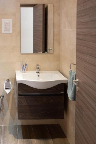 a bathroom with a sink and a mirror at For Rest Aparthotel in St Paul's Bay