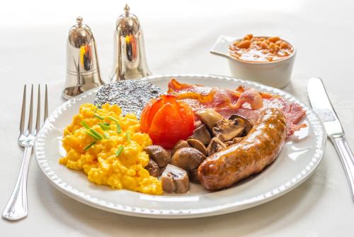 a plate of breakfast food with eggs sausage and vegetables at The Devonian in Douglas