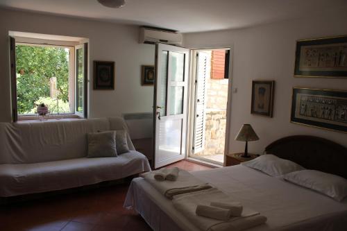 a living room with a bed and a couch at Old Town Apartment MARTIN in Budva