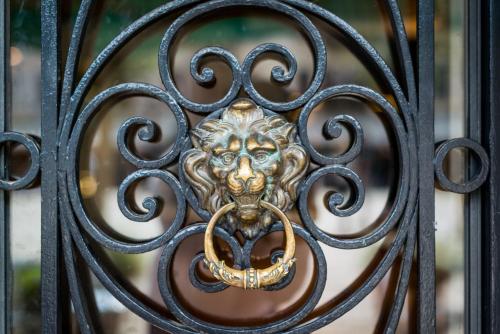 a metal door with a lion mask on it at Hotel Santo Stefano in Venice
