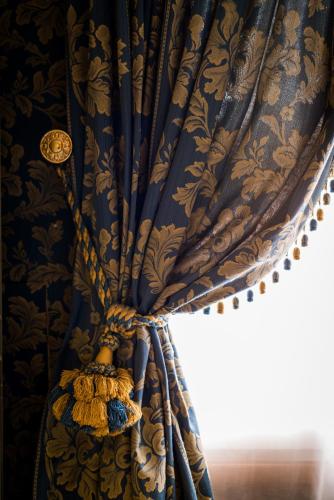 a curtain in a room with a window at Hotel Santo Stefano in Venice