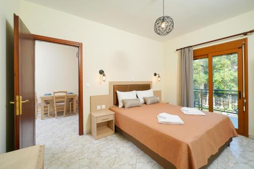 a bedroom with a bed and a balcony at Villa Karydies in Limenas