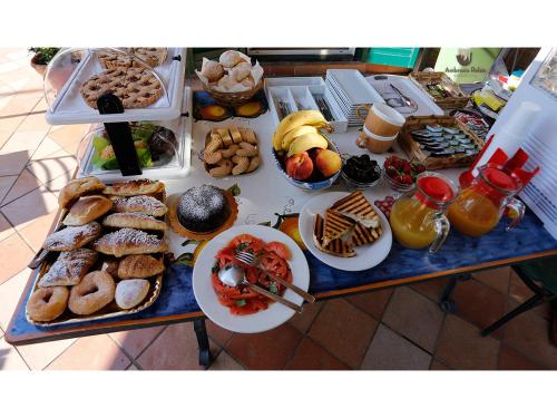 a table topped with lots of different types of pastries at Ambrosio Relais in Sorrento