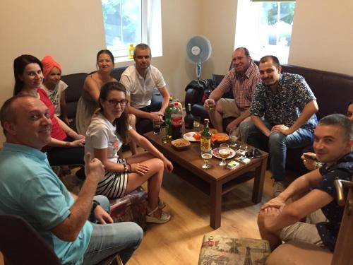 a group of people sitting in a living room at Nomado Hostel in Varna City