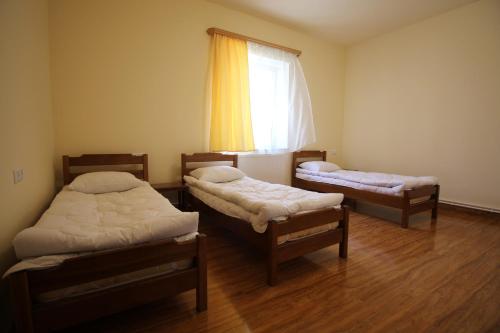 a room with three beds and a window at Karin's B&B in Sisian