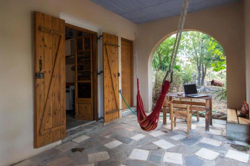 a room with a hammock and a table with a laptop at Mavilia Traditional Guesthouse in Ligourio