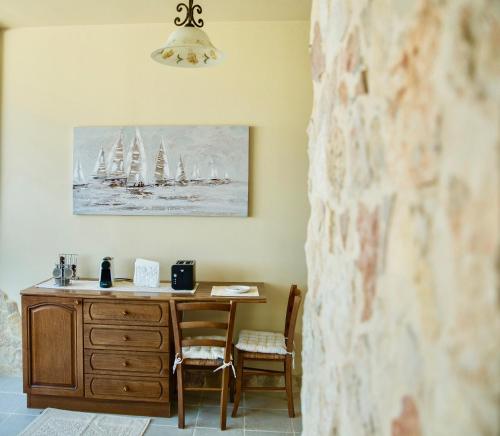 a desk in a room with a painting of sailboats at Casa Vista with spectacular view and gas BBQ in Capitana