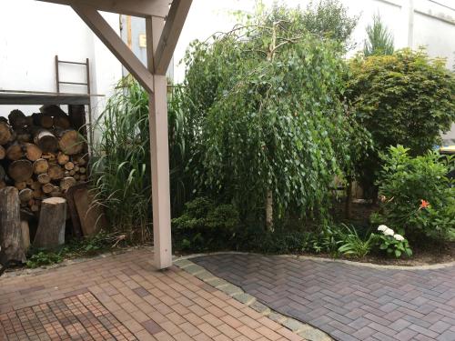 a pavilion with a garden with trees and bushes at Appartment Maggy in Bad Liebenwerda
