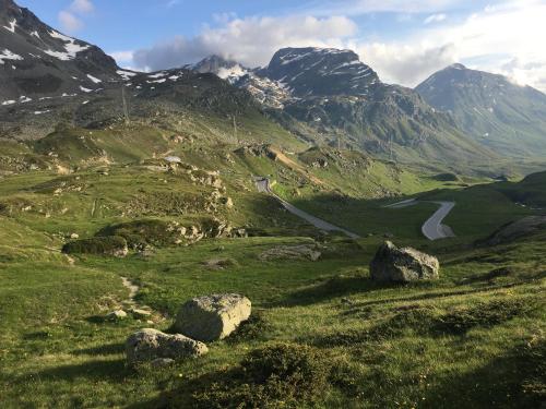 a view of a mountain valley with rocks and a road at Ospizio La Veduta in Bivio