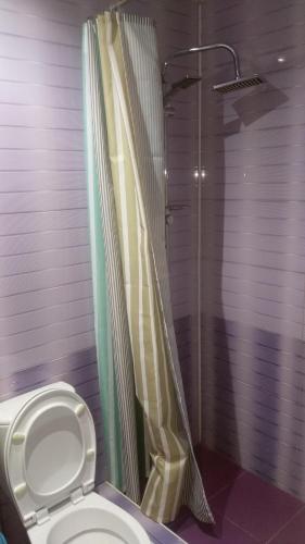 a bathroom with a shower and a toilet at Guest House Guriani in Grigoleti