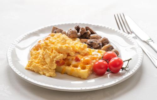 a plate of breakfast food with waffles and mushrooms at The Devonian in Douglas
