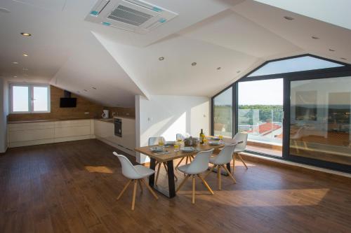a kitchen and dining room with a table and chairs at Villa Marijeta Hvar in Hvar